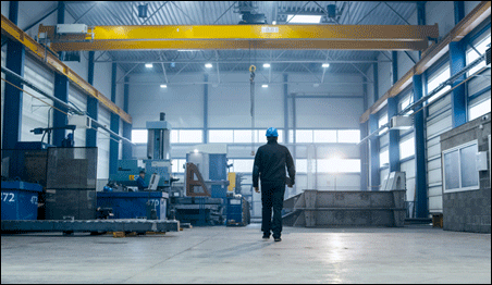 Factory worker walking through industrial facility