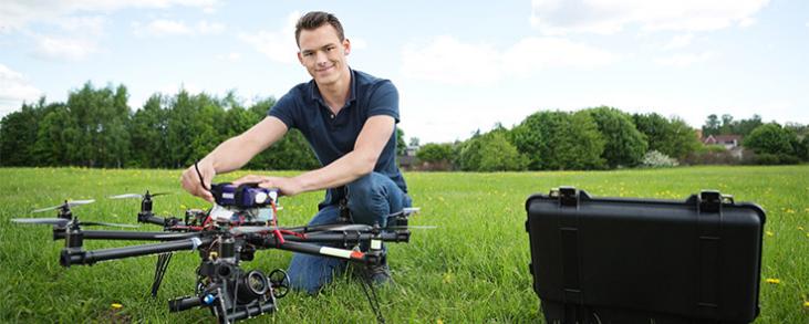 image of man holding drone