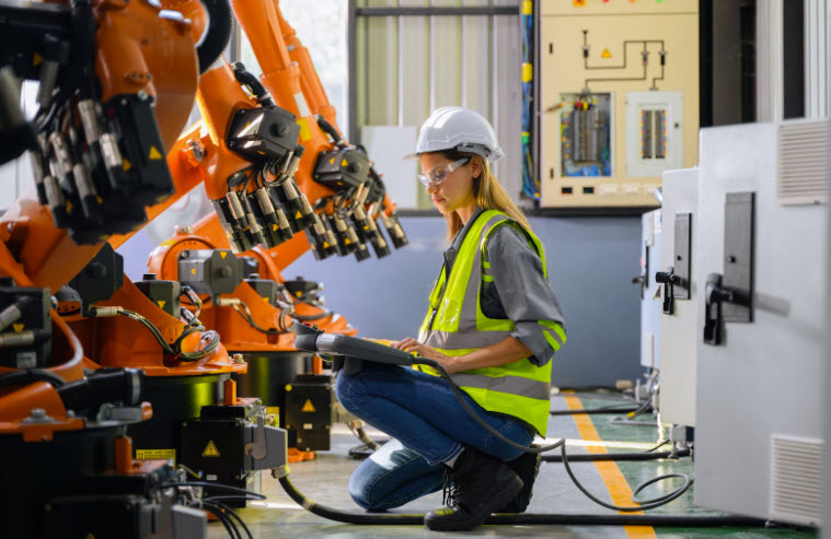 Technician working with robot at factory