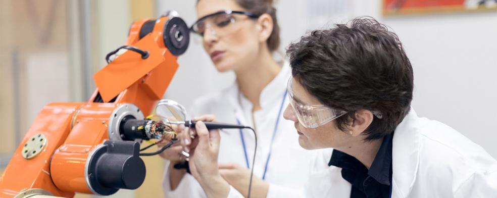 Image of women working on a robot